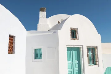 Traditional cycladic architecture in Santorini island, Greece. White painted house with turquoise door and windows © smallredgirl