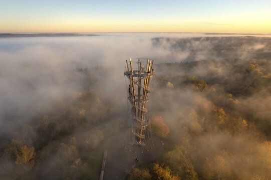 Tower in the fog reveals itself at sunrise, surrounded by autumnal forest landscape, Sch&ouml;nbuchturm, Herrenberg, Germany