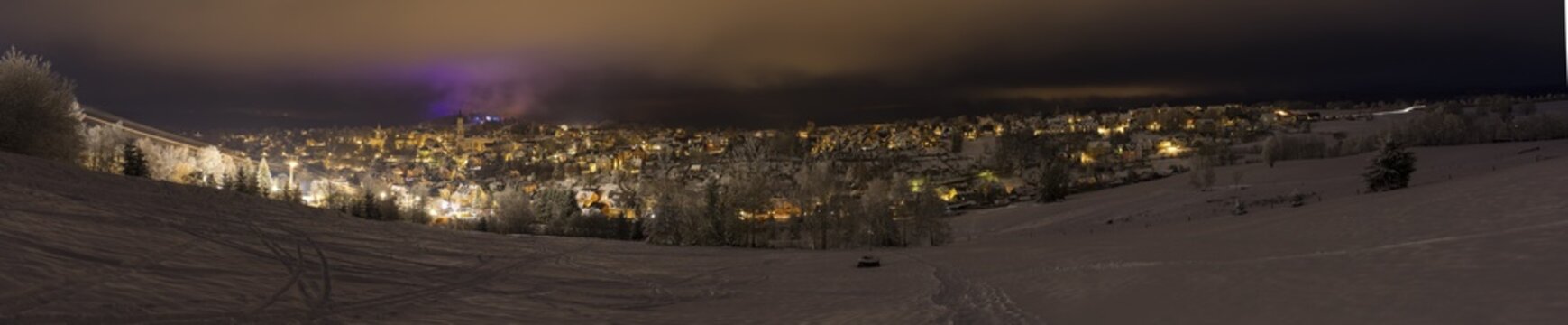 Panoramic photo, town view with snow and night, Eibenstock in the Ore Mountains, Saxony, Germany