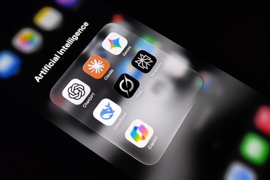 Various artificial intelligence chatbot apps ChatGPT, Gemini, Claude, Copilot, Perplexity, DeepSeek, Grok, Meta AI are seen on an iPhone.