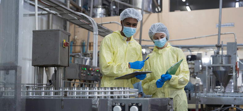 Canned seafood industry. Canned fish factory. Worker wear uniform working at production line of seafood processing