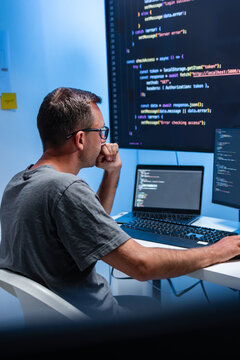 Male Programmer Working on Coding Tasks for Software Development, Cloud Systems, and Data Center Technology, Focused on Screen While Developing Intelligent Software for LLM and Machine Learning.