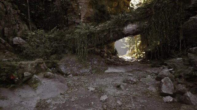 Cryptic entrance to mossy cave reveals secret subterranean puzzles. Mysterious portal shrouded in moss and stones unlocks ancient underground enigma
