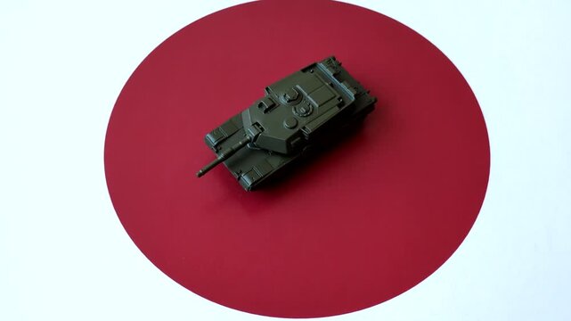 A tank on the Japanese flag as a conceptual backdrop representing defense and preparation against attack. A tank on the Japanese flag as a background for your design