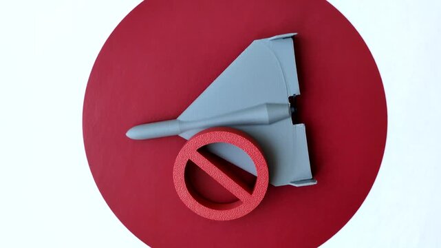 A Shahed drone featuring a prohibition symbol on the Japanese flag, serving as a conceptual background for themes of defense and preparation against attack
