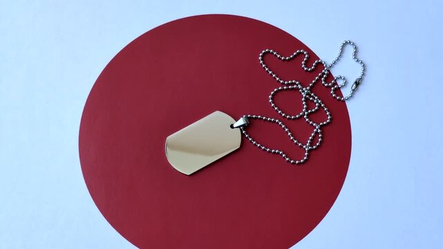 A dog tag on the Japanese flag, serving as a conceptual backdrop representing defense and preparation against attack. A dog tag on the Japanese flag as a background for your design