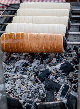 Preparation of the Hungarian traditional kurtos kalacs roasted over charcoal