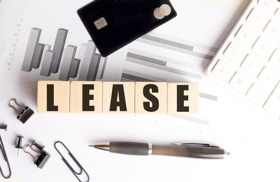 Lease concept with credit card, calculator, financial charts and office supplies representing leasing agreements, rental financing