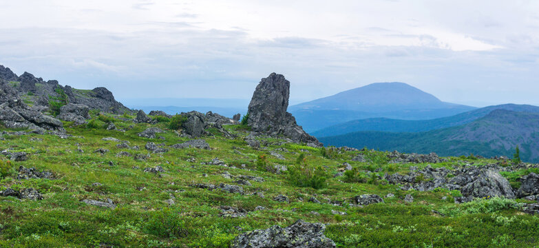 Mountain landscape with green grass and rocks. Urals.