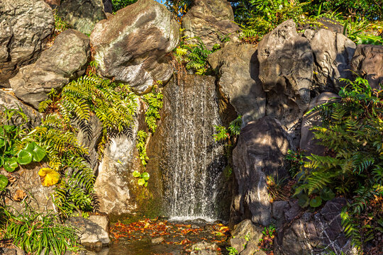 Close-up of the waterfall flowing down the beautiful rocks at Ninomaru Garden December 2023