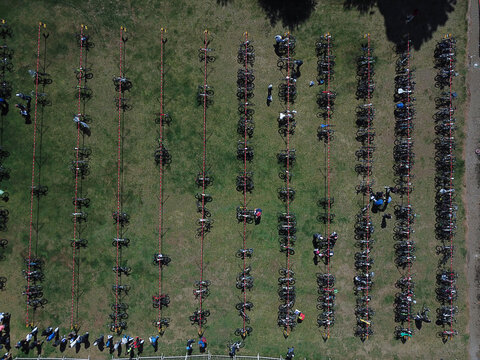 Aerial view of rows of bicycles parked in a grassy field during a sporting event in San Carlos de Bariloche, Rio Negro Province, Argentina.
