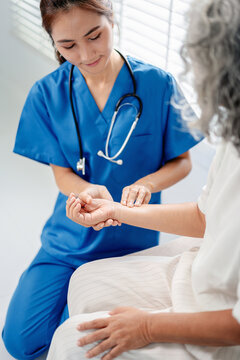 Healthcare professional assessing elderly patient pulse medical