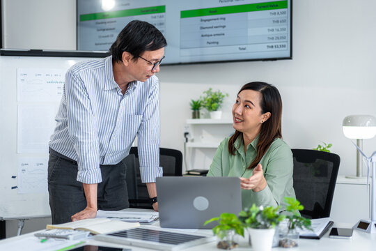 Corporate executives and colleagues discuss vital environmental conservation strategies in a professional office setting for future sustainability plans