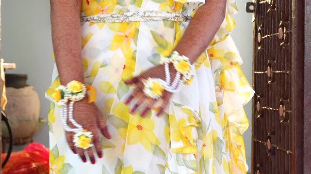 Indian Bride Hands with Mehndi and Pearl Flower Jewelry