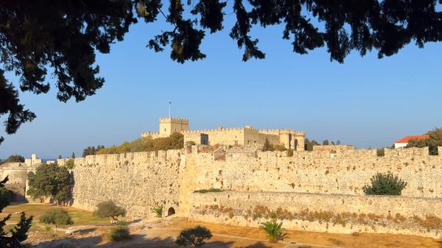 View of the Saint Nicholas Fort through the trees in Rhodes city, Greece