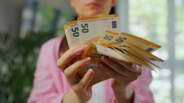 Woman counting euro bills, close-up