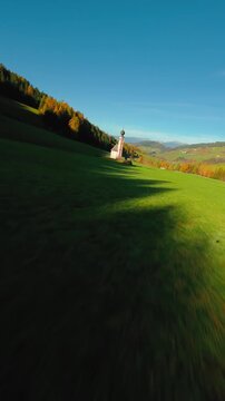 FPV Aerial view of the Church of St. Johann in Ranui at South Tyrol, Italy. 