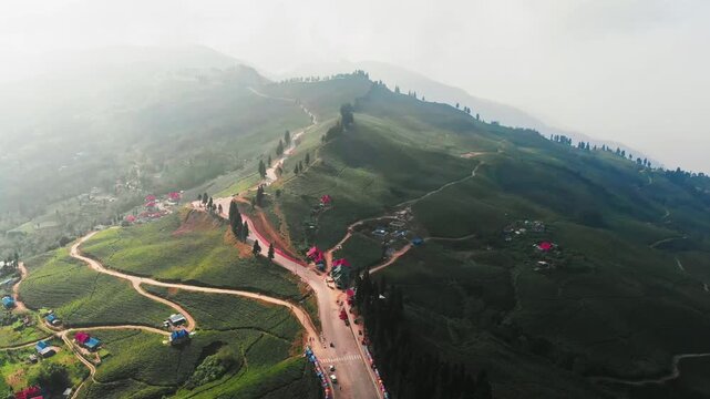 Panoramic aerial view of Kanyam chiyabaari hills showing extensive tea bush cultivation across multiple ridges
