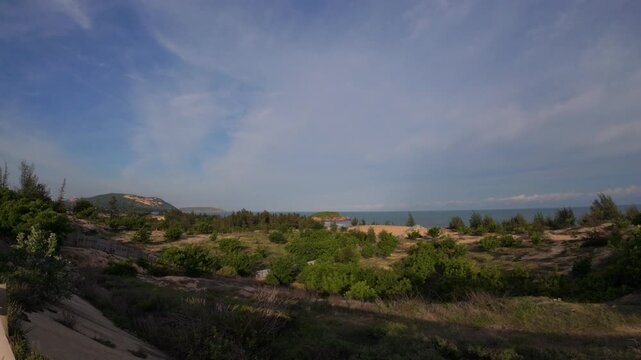 Cinematic static shot of coastal mountains and blue ocean in Mui Ne