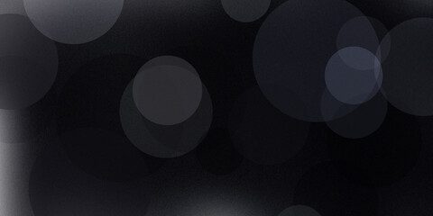 Abstract dark background featuring soft gray bokeh circles and textured noise patterns creating mysterious sophisticated mood. © Ffd