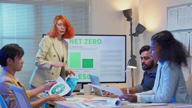 Diverse multiracial business team sitting in night office presenting ESG restructuring plan for clean energy profit growth, corporate consulting analysts strategy meeting concept