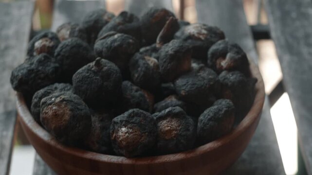 Bowl with Peruvian black maca from the Andes, classified as a superfood.