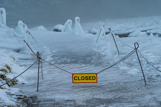 Closed icy footpath at Seljalandsfoss waterfall in winter, Iceland