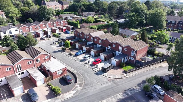 Aerial drone 4K scene showing Wirral suburban streets glowing under strong sunlight Wirral