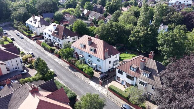 Aerial drone 4K footage showing Wirral homes illuminated by bright clear daylight Wirral