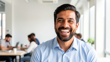 Fototapeta premium joyful diverse businessman laughing in bright modern coworking space suitable for corporate happiness marketing