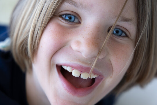 Happy smiling blond boy portrait, big blue eyes