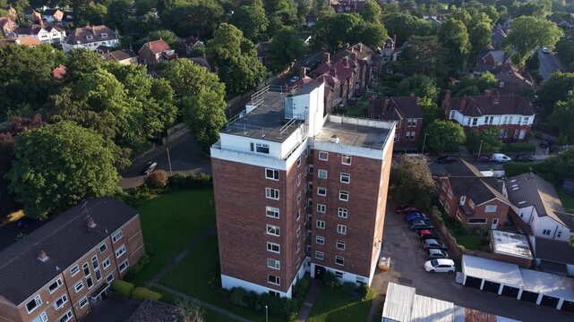 Aerial drone 4K footage showing housing blocks glowing beneath warm golden hour colours England