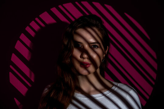 Beautiful woman portrait in studio with shadow lines