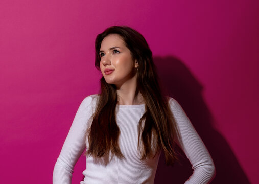 Smiling woman, minimalist portrait in studio, isolated on a magenta background