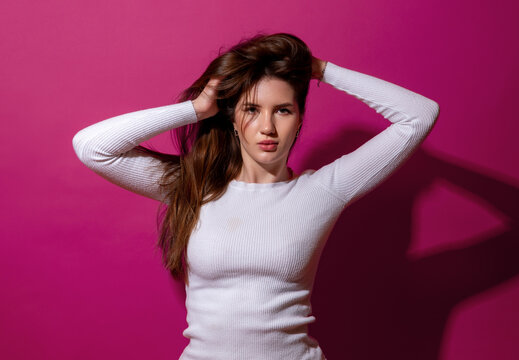 Young woman with long beautiful hair, minimalist portrait in studio