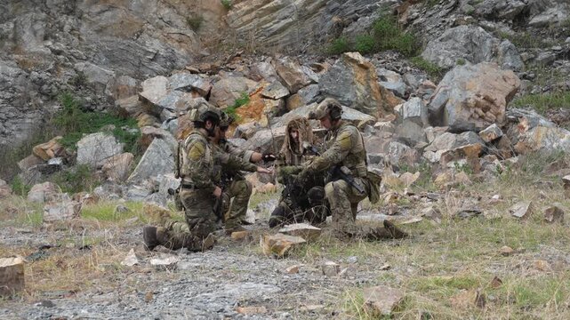  group of soldiers in military uniforms carrying BB guns encountered a black smoke grenade effect, causing soldiers to fall, and the enemy was affected during a military exercise while playing a game