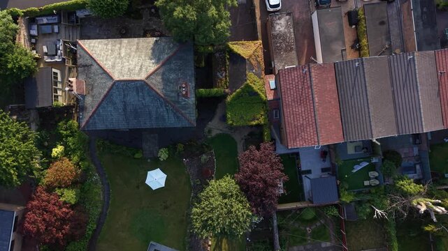 Aerial drone 4K footage showing long rows of homes glowing beneath sunset tones England