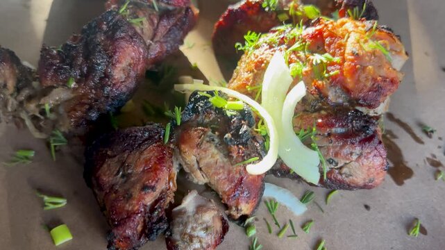 Delicious pork shashlik. Grilled meat, pieces with onions and dill. Caucasian barbecue.