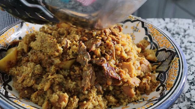Serving Moroccan trid with qaddid cured meat and lentils
