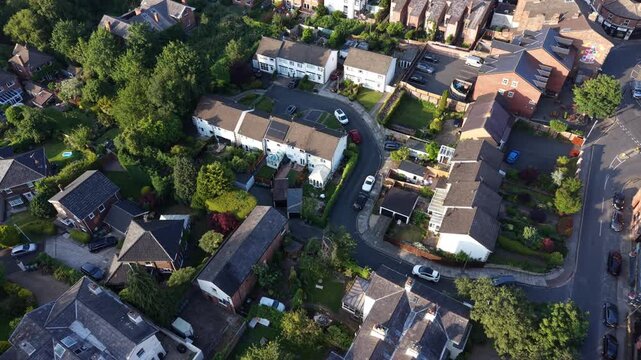 Aerial drone 4K footage showing housing estates glowing under warm golden hour illumination England