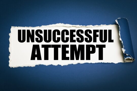 Conceptual text unsuccessful attempt shown behind torn dark blue paper