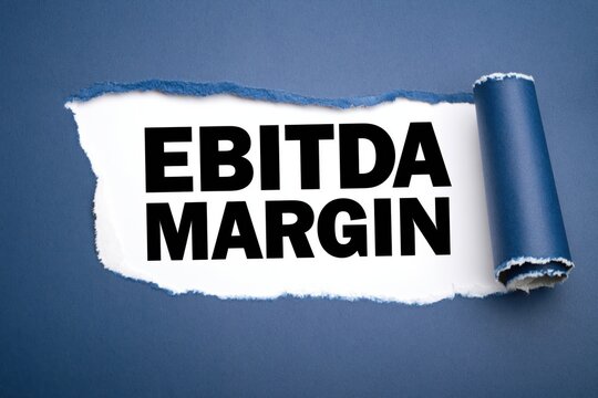 Ebitda margin corporate financial text visible under torn blue paper