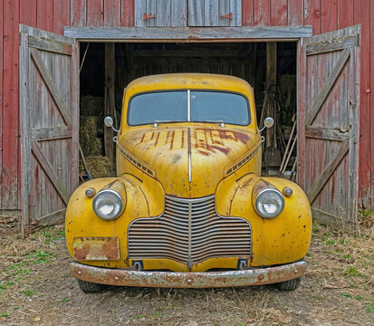antique 1930's sedan abandoned in a barn