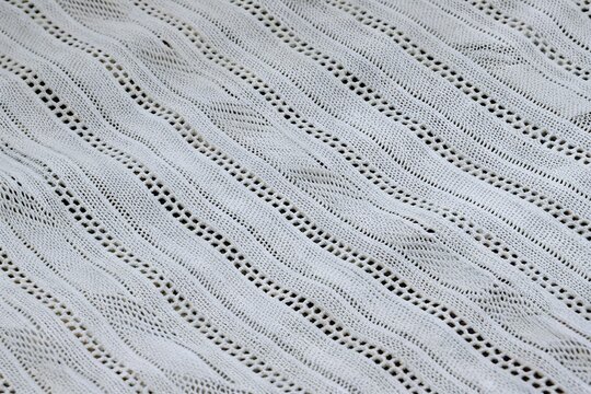 white textured pointelle cable stripe knit fabric background close up
