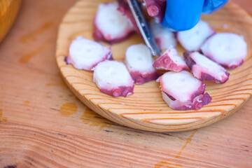 Detail of preparing Spanish octopus tapas The Concept of traditional cooking © VicVaz
