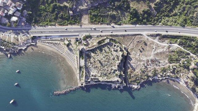 Aerial Drone View of Korykos Castle and Mediterranean Coastline in Mersin, Turkey, Historic Fortress by the Sea at Sunset