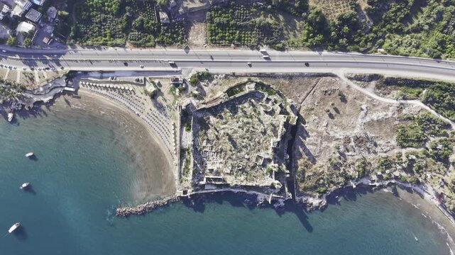 Aerial Drone View of Korykos Castle and Mediterranean Coastline in Mersin, Turkey, Historic Fortress by the Sea at Sunset