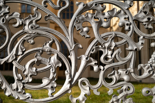 Detailed view of elegant vintage metal railing showcasing classic craftsmanship on a sunny day