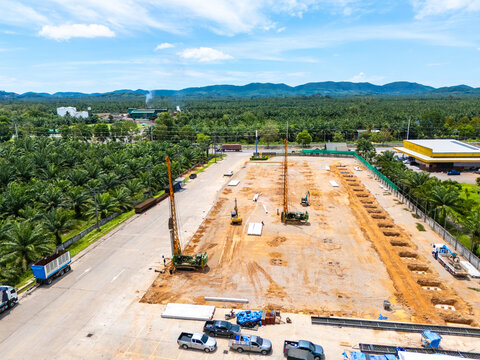 Aerial view of cranes and pile drivers at work on a construction site, driving piles for industrial plants and large buildings. Project site factory 