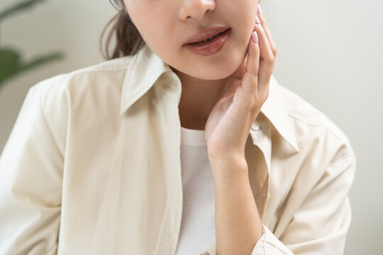 Jaw pain, health care concept. Teeth pain and dentistry asian young woman, girl suffering touching her cheek. Female feeling painful toothache. Unhappy feel bad, diseases in oral, ache nerve and molar